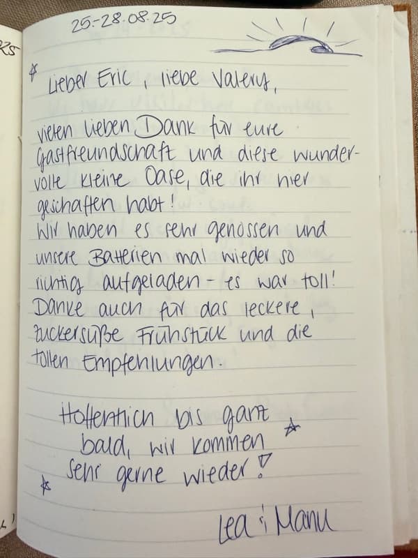 Handwritten German guestbook note thanking Eric and Valery for their hospitality, breakfast and local tips, decorated with a small sun and stars.