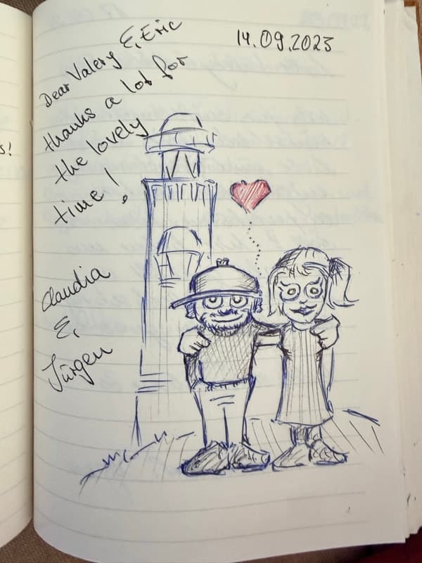English guestbook message with a blue ink drawing of a couple beside the Noordwijk lighthouse and a small red heart.