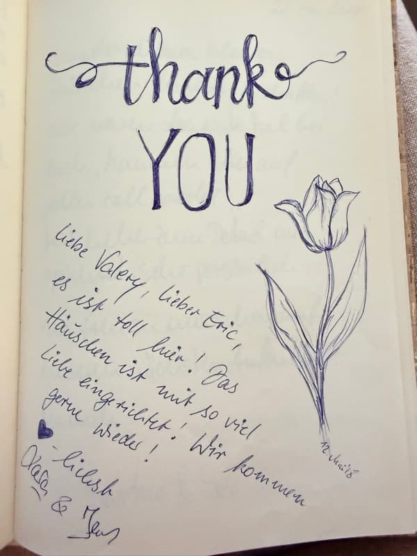 German thank-you message in the guestbook beside a large blue ink drawing of a tulip and a small heart.