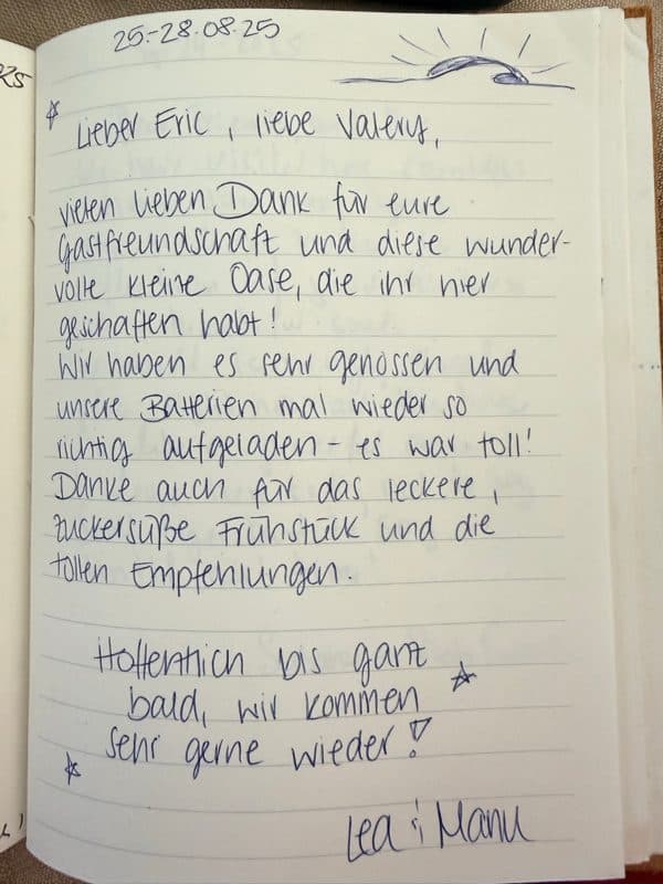 Handwritten German guestbook note thanking Eric and Valery for their hospitality, breakfast and local tips, decorated with a small sun and stars.